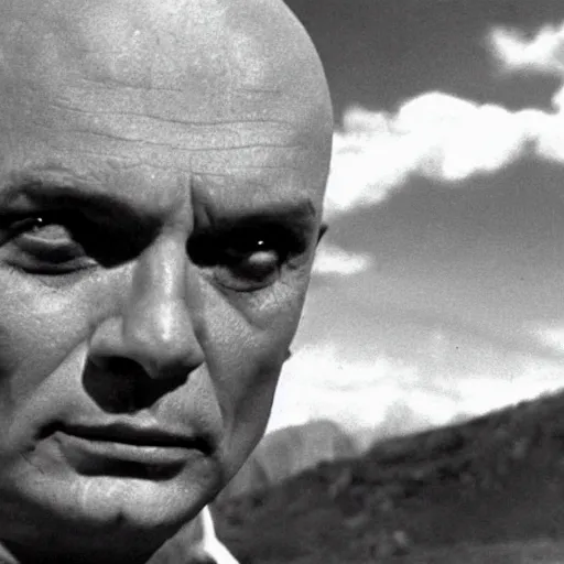 Image similar to a cinematic still of a disembodied head of Yul Brynner judging and scowling at the village that lives on the land below him