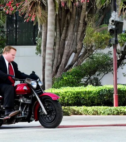 Image similar to Andy Richter is dressed in a black suit and a red necktie and riding a motorcycle into a studio lot. The studio lot is filled with Soundstages and movie trailers. It is a bright afternoon and overcast.