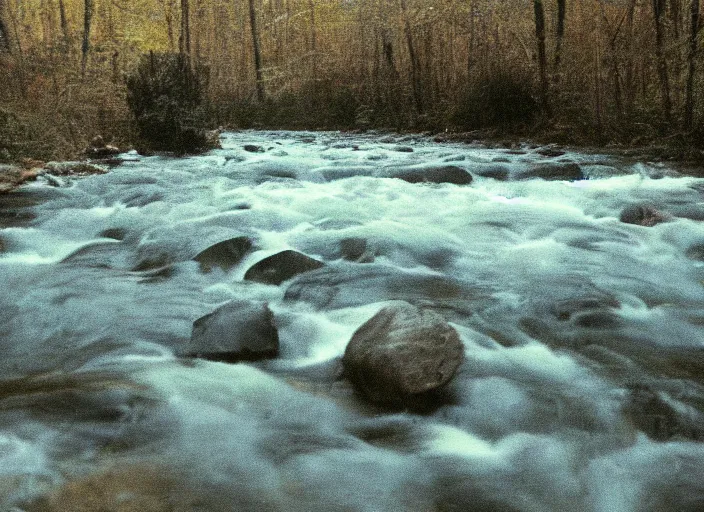 Prompt: very low quality blurry vhs footage of a river