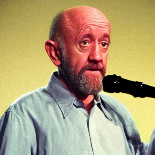 Prompt: mike ehrmantraut pretending to be george carlin on stand up night