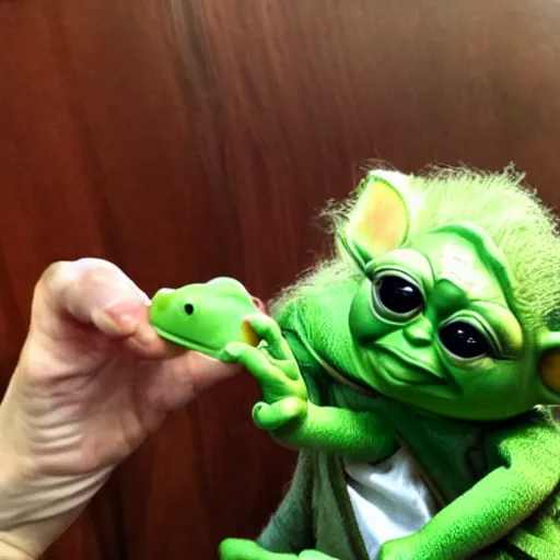 Image similar to baby yoda trying to eat kermit the frog,