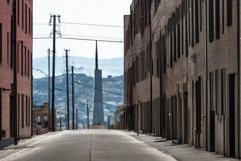 Prompt: looking down street, warehouses lining the street. hill background with radio tower on top. telephoto lens compression.