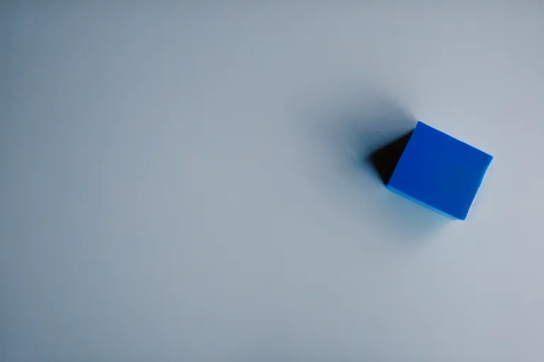 Prompt: single blue cube on white studio floor, soft light, 3 5 mm