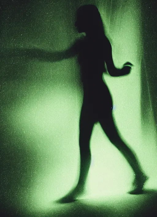 Image similar to a thin female silhouette walking, astral projection, green glowing aura, out of body, film grain, cinematic lighting, experimental film