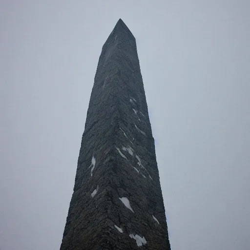 Image similar to a monolithic obelisk towering over a mountain in a taiga. overcast sky, grainy, snowing.