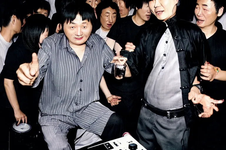 Image similar to a middle aged chinese dj with thick hair, wearing black trousers and grey shirt, in a nightclub. by david lachapelle