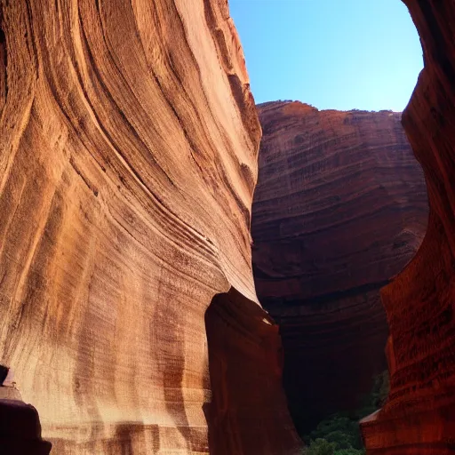 Image similar to A humongous canyon with temples etched into the walls of the canyon.