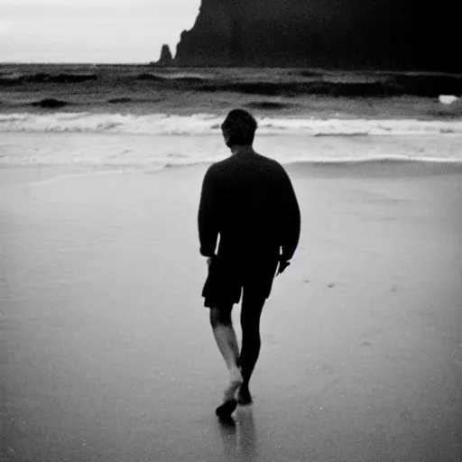 Prompt: a film photo of a man, athletic, walking on beach in Oregon, facing camera, Kodak gold 200 film