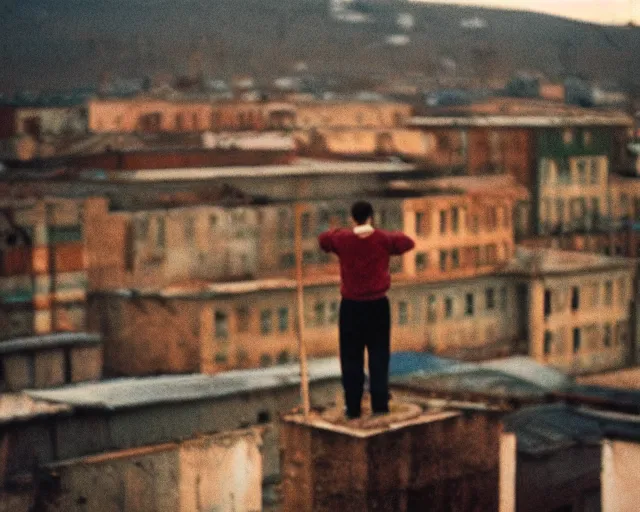 Image similar to lomo photo of man standing on the roof of soviet hrushevka, small town, cinestill, bokeh, out of focus