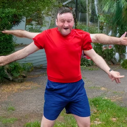 Image similar to a english irish middle aged man with brown moptop hair and red cheeks is clean shaven. he is wearing a dark blue tshirt and shorts. he dances with his arms excitedly like a chicken in his kitchen