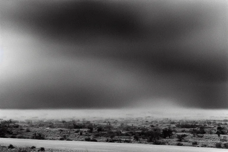 Prompt: ansel adams. fujifilm 5 0 - 1 4 0 mm f 2. 8 long - exposure photographs that convey ominous and calm spooky. dust bowl blues incoming dust storm