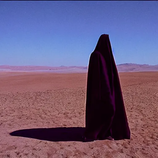 Image similar to a man wearing a long cloak and hood, in the desert, film still, panavision panaflex