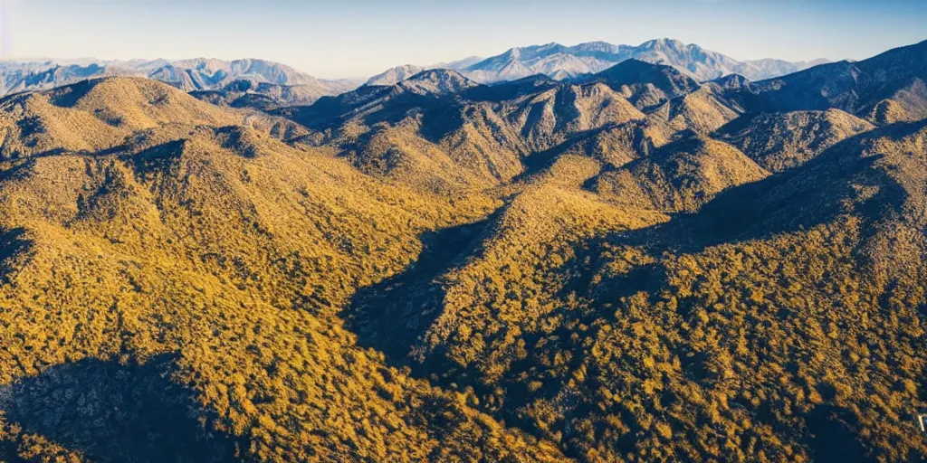 Prompt: drone shot photo of a landscape with mountains and acanyon, wallpaper, very very wide shot, national geographic, award landscape photography, professional landscape photography, sunny, day time, beautiful