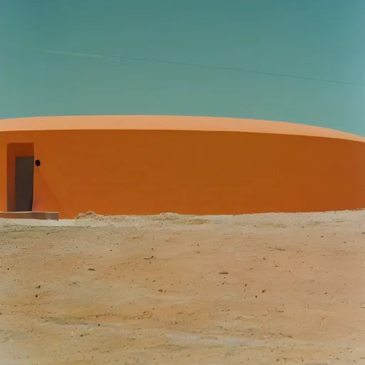 Prompt: a man in neon colored clothing standing outside a Non-Euclidean orb-like clay house sitting in the desert, vintage photo, beautiful cinematography, blue sky, film grain, James Turrell