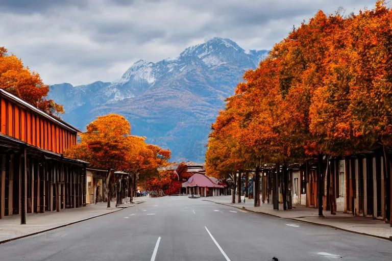 Image similar to warehouses lining a street, with an autumn mountain directly behind, lens compressed, photography