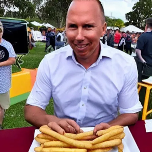 Image similar to peter dutton has revealed he was bombarded with text messages after he was pictured awkwardly eating a dagwood dog at a carnival