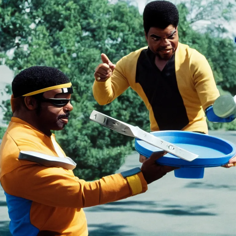 Image similar to geordi laforge wearing visor and a frisbee and random kitchen tools on his head