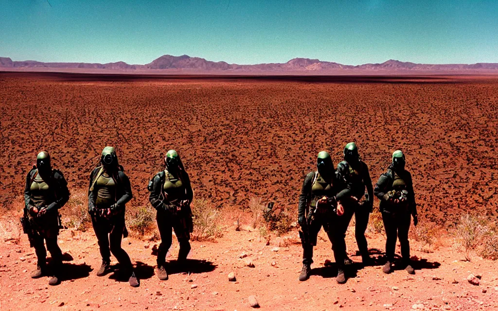 Image similar to a team of five people in dark green tactical gear like death stranding and masks, red mesas behind them, look at a desert oasis in the distance. They 're afraid. dusty, red, mid day, heat shimmering, 35mm film