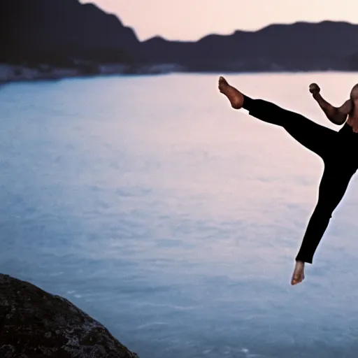 Prompt: Bruce Lee doing a kick on a rock while the sun rises in the background, HD, high resolution, cinematic, 4K