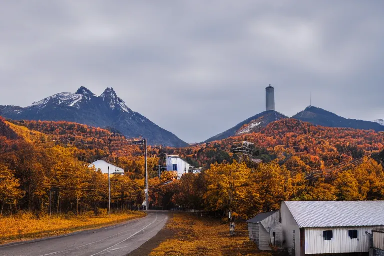 Image similar to warehouses lining a street, with an autumn mountain directly behind, radio tower on mountain, lens compressed, photography