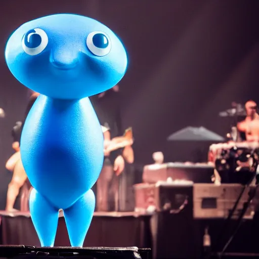 Image similar to a small smooth blue creature in the shape of a sausage stands on a huge microphone on the stage