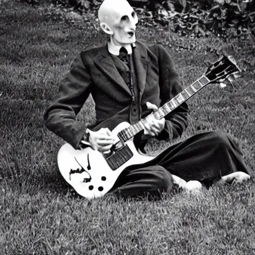 Prompt: vintage photograph of count orlok crouched on the lawn outside his castle, playing the blues on guitar, 4 k