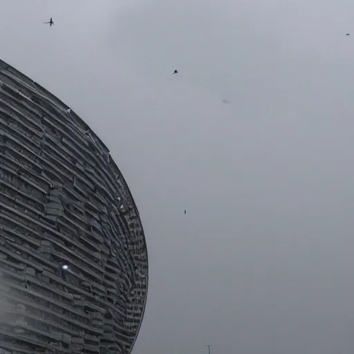 Image similar to A giant mechanical ring hovers horizontally above a city. The sky is dark and cloudy.