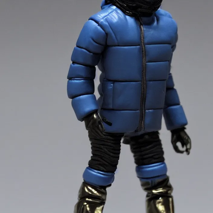 Prompt: a action figure of kanye west using a full face covering black mask, a small, tight, undersized reflective bright blue round puffer jacket made of nylon and big black balenciaga rubber boots, figurine, detailed product photo