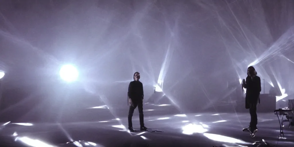 Image similar to Thom Yorke singer songwriter, Radiohead group of people on stage playing instruments, elaborate stage effects, dust, smoke, giant LED screens, colored projections, ultrafine detail, glowing thin wires, smoke, high contrast, projections, a screenshot by David Gilmour Blythe, holography, tesseract, volumetric lighting, anamorphic lens flare