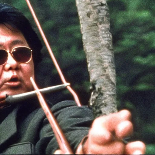 Prompt: a still of Kim Jong-il in the role of John Rambo holding a bow in Rambo First Blood, 35mm film, classic iconic Rambo pose