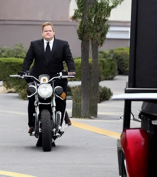 Image similar to Andy Richter is dressed in a black suit and a red necktie and riding a motorcycle into a studio lot. The studio lot is filled with Soundstages and movie trailers. It is a bright afternoon and overcast.