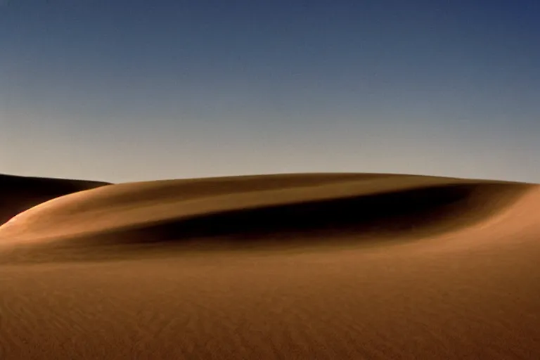 Prompt: a cinematic photograph of a sand wave in a serene vast desert, dune movie, cinematic, movie still, dramatic lighting, by bill henson, 1 6 : 9 ratio