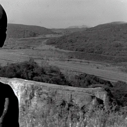 Image similar to a cinematic still of a disembodied head of Yul Brynner judging and scowling at the village that lives on the land below him