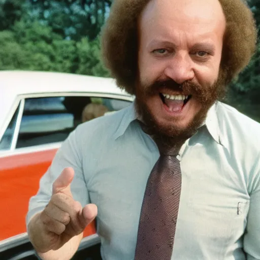 Image similar to a deteriorating color photo from 1 9 7 2 of a persistent used car salesman that looks like a cross between bill burr and fred savage with his hand on a junker car