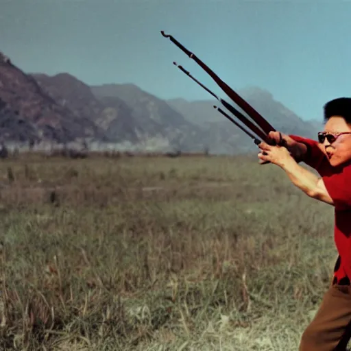 Image similar to filmstill of Kim Jong-il wearing a red bandana and aiming an arc in the role of Rambo, cinemascope, Eastman Color Negative 50T 5251 Neg. Film