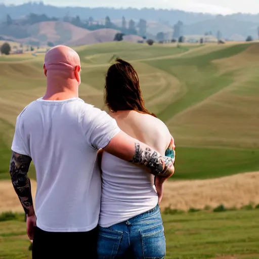 Image similar to portrait of a young chunky bald white male tattoos and his young white female brown hair wife with tattoos. male is wearing a white t - shirt, tan shorts, white long socks. female is has long brown hair and a lot of tattoos. photo taken from behind them overlooking the field with a goat pen. rolling hills in the background of california and a partly cloudy sky