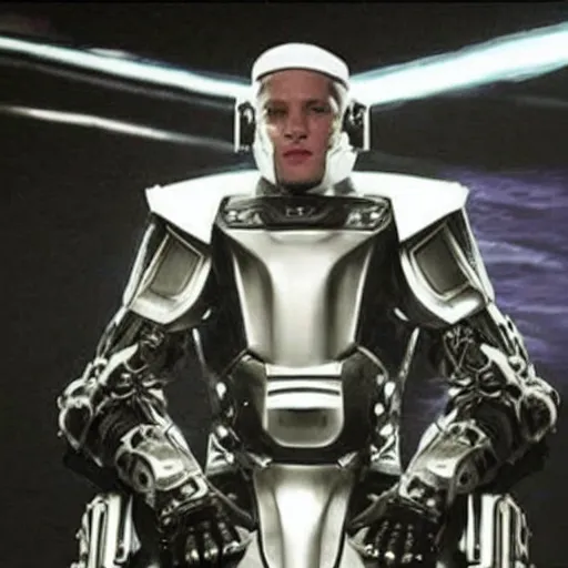 Image similar to eminem wearing a futuristic armored mask with large a large video screen image of eminem where his face should be, and he is wearing black leather exoskeleton mechanical body armor. a mini - gun is attached to the end of a robot arm that mounted on his shoulder - h 6 4 0