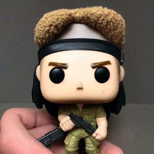 Image similar to a Funko Pop collectible of Rambo. headband. holding in one hand automatic rifle. no text