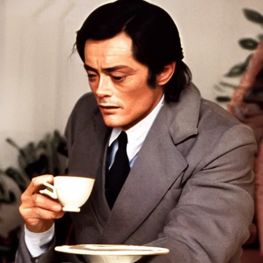 Image similar to Still in technicolor of Alain Delon holding a tea cup and a madeleine fromage the 1973 film by Luchino Visconti In search of lost time