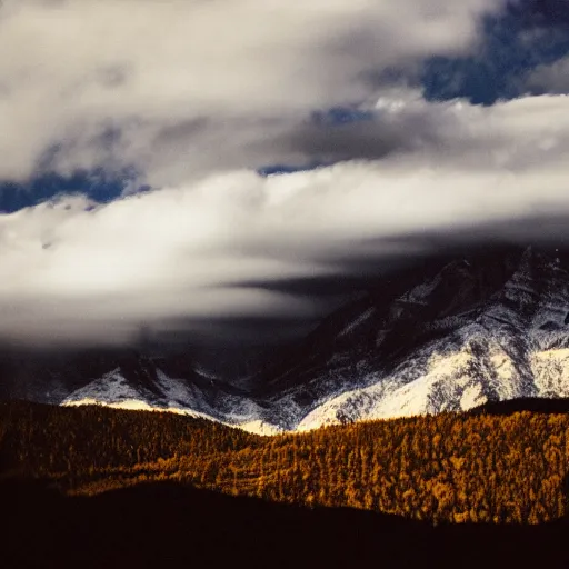 Image similar to mountains of light under a bright cloudy sky, overexposed grainy photograph