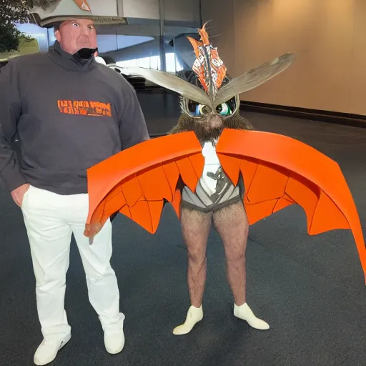 Image similar to ripped physique winged man Norm MacDonald disguised as a mothra whilst wearing a traffic cone hat tradd moore