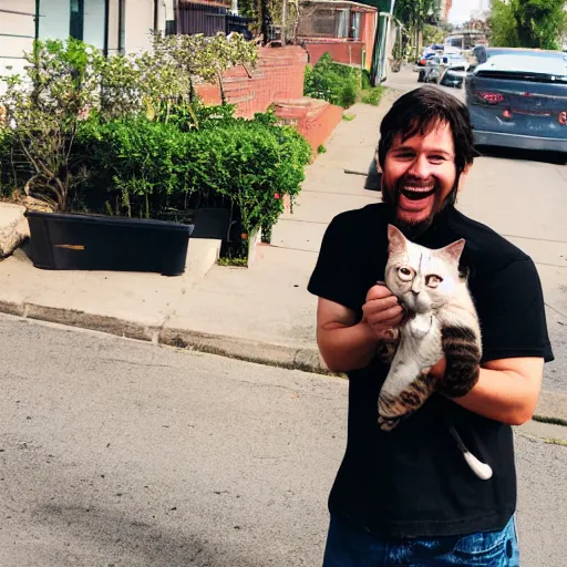 Prompt: Action photo of a happy guy wearing black casual clothes in his late 20's holding a skinny tabby cat next to a garbage dumpster