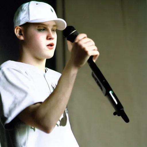 Prompt: 19-year-old white boy wearing backwards baseball cap, baggy jeans, rapping into microphone, nü metal concert, rap metal, alternative metal, 1999 photograph