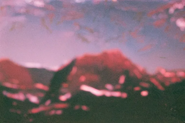 Image similar to film color photography, close-up mirror that reflected red at the green lawn, no focus, mountains in distance, 35mm
