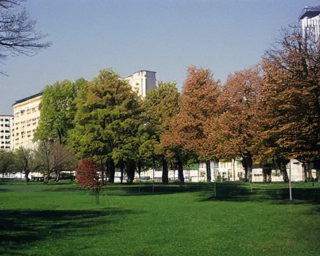 Prompt: a park with trees and buildings in the background, a photo by zlatyu boyadzhiev, deviantart, danube school, panorama, 1 9 9 0 s, creative commons attribution