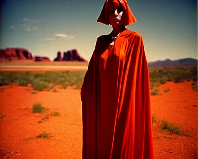 Image similar to by bruce davidson, by andrew boog faithfull redscale photography evocative. a mystical woman in scarlet robes, conical hot in front of a desert mesa.