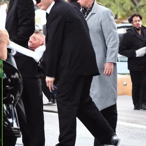 Image similar to quentin tarantino at a funeral, wearing a yarmulke, paparazzi