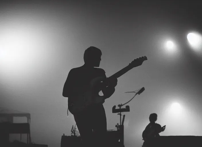 Image similar to a 2 8 mm macro photo from the back of a guitarist in the spotlight on stage at a festival in silhouette in the 1 9 6 0 s, bokeh, canon 5 0 mm, cinematic lighting, dramatic, film, photography, golden hour, depth of field, award - winning, 3 5 mm film grain