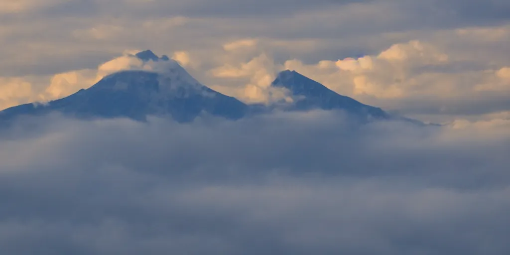 Image similar to a mountain floats in the clouds and shines brightly