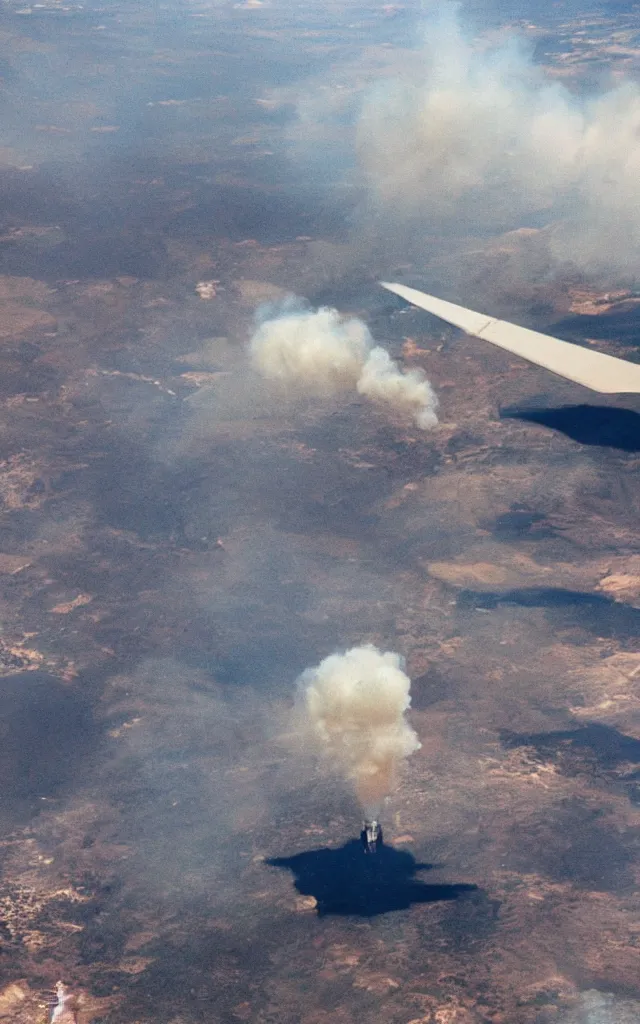 Image similar to a photograph out of a plane window, the plane engine is burning